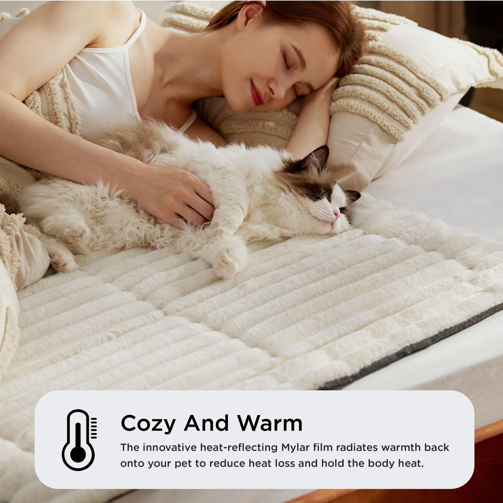 Self-warming pet mat on a bed with cat and owner
